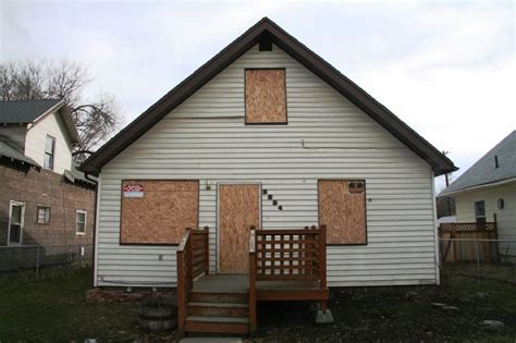 house boarded up with metal|boarding up damaged house.